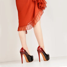 Load image into Gallery viewer, Red high-heeled shoes worn with a red skirt on a light background