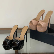 Load image into Gallery viewer, Black and beige high-heeled shoes on a reflective surface with a neutral background