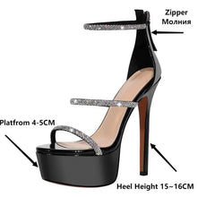 Load image into Gallery viewer, Black high-heeled sandal with platform and glittery straps, labeled with measurements and features.