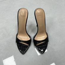 Load image into Gallery viewer, A pair of women's pointed-toe mule heels with a glossy black crocodile-embossed patent finish and a beige insole, photographed from a top-down angle on a gray floor.
