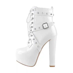 White ankle boot with studded details on a white background