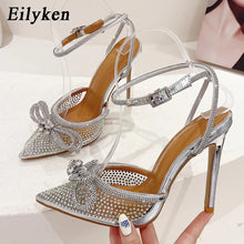 Load image into Gallery viewer, Silver high-heeled shoes with rhinestone details on a white background, featuring the brand &#39;Eilyken&#39;.