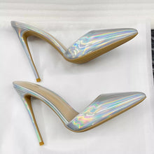 Load image into Gallery viewer, A pair of pointed-toe high heels with an iridescent holographic finish and tan soles, displayed on a white textured background.