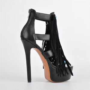 Black high-heeled sandal with fringe details on a white background