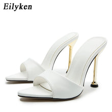 Load image into Gallery viewer, White pointed-toe mule heels with thin gold stiletto heels and double straps, shown on a clean white background with the brand name Eilyken in the top left corner.