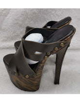 Load image into Gallery viewer, Brown high-heeled sandals with gold studs on a gray background