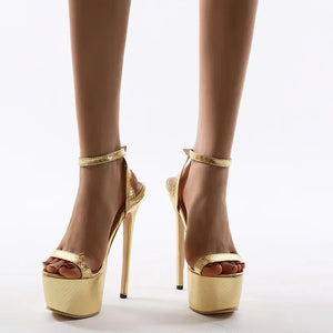 Gold high-heeled sandals on a white background